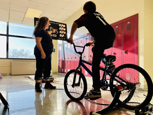 MGE leads an energy presentation with students featuring the Power Pedal bicycle