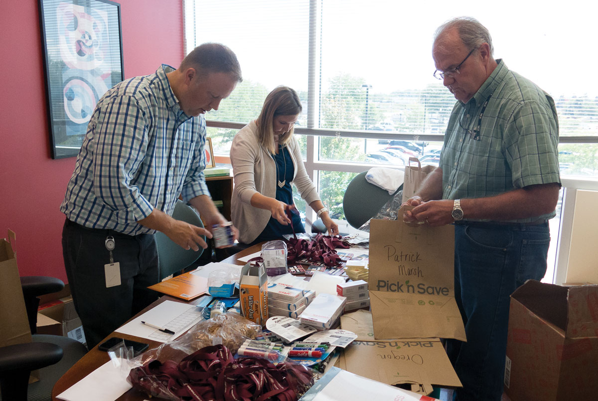 MGE employees assemble school supplies at the Urban League of Greater Madison