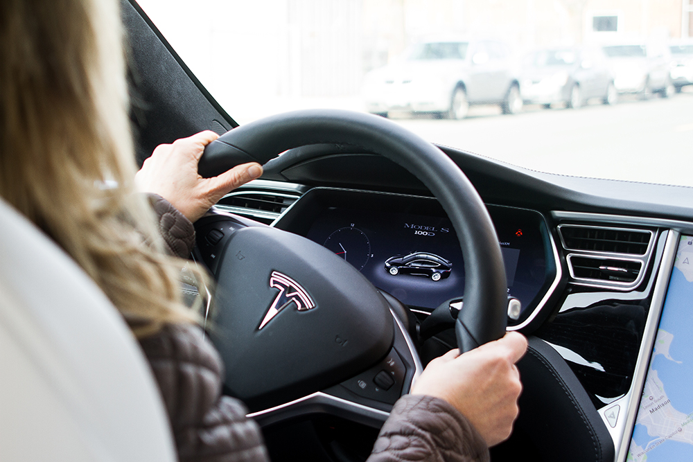 Woman driving a Tesla