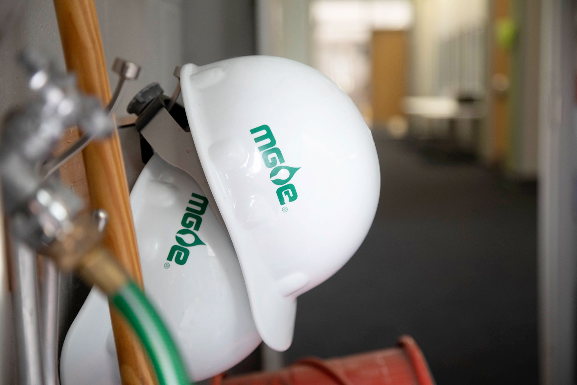 Two white MGE hard hats 