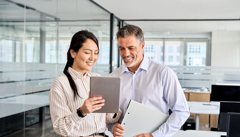 Coworkers reviewing information on a tablet.