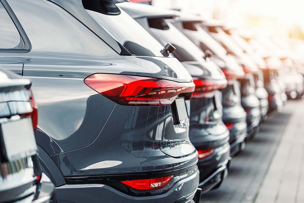 Row of new vehicles at a car lot.