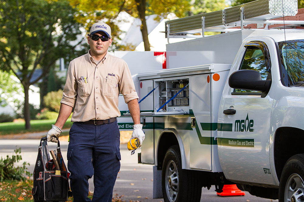 MGE employee approaching home for meter maintenance.