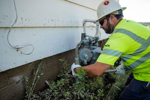 MGE employee working on an energy meter.