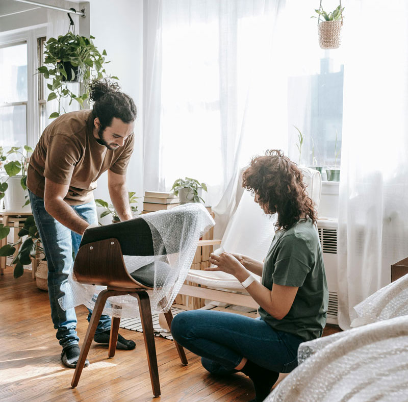 a young couple packing up boxes to move