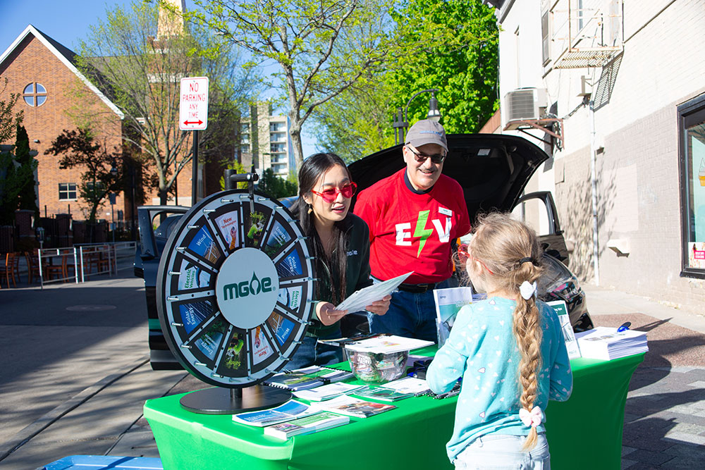 MGE employees staff a booth at the Madison Night Market, funded in part by the MGE Foundation.