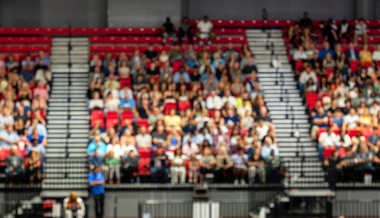 people sitting in sports stadium