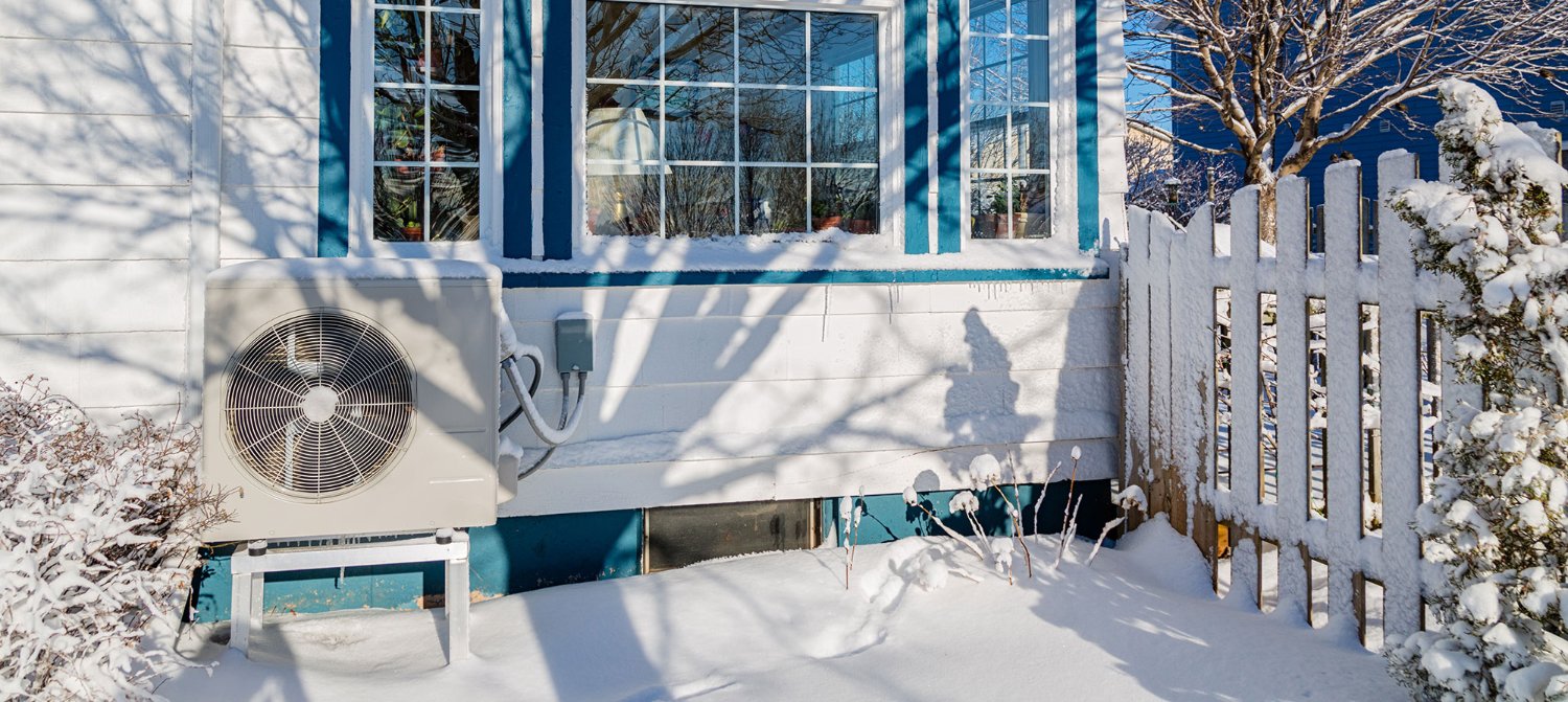 Heat pump outside of a home in winter.