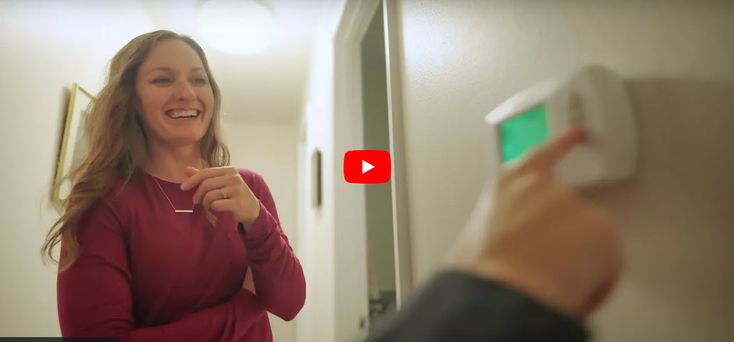 Woman learning about a programmable thermostat.