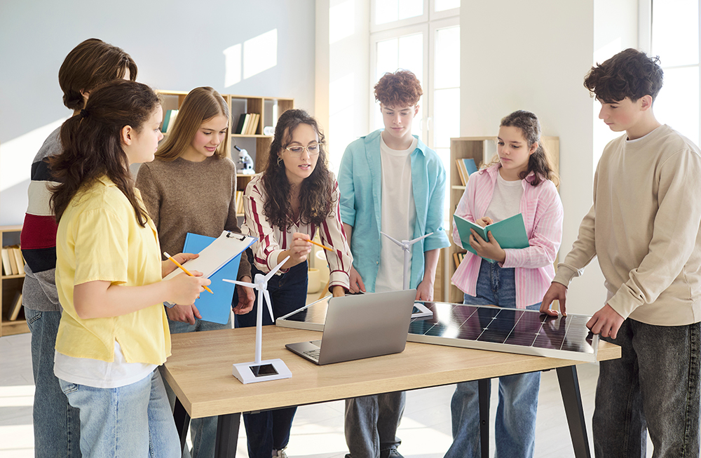 Students gathered around teacher discussing energy